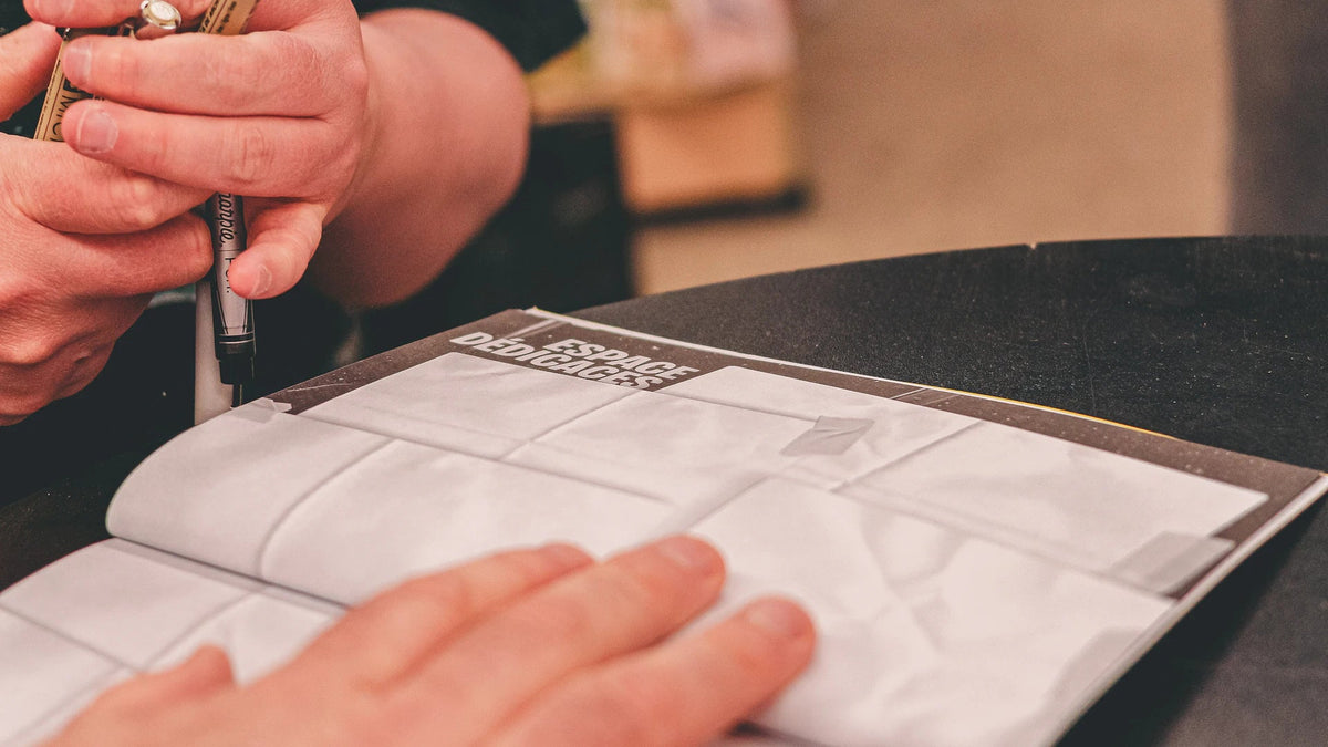 Hands point to an open notebook.