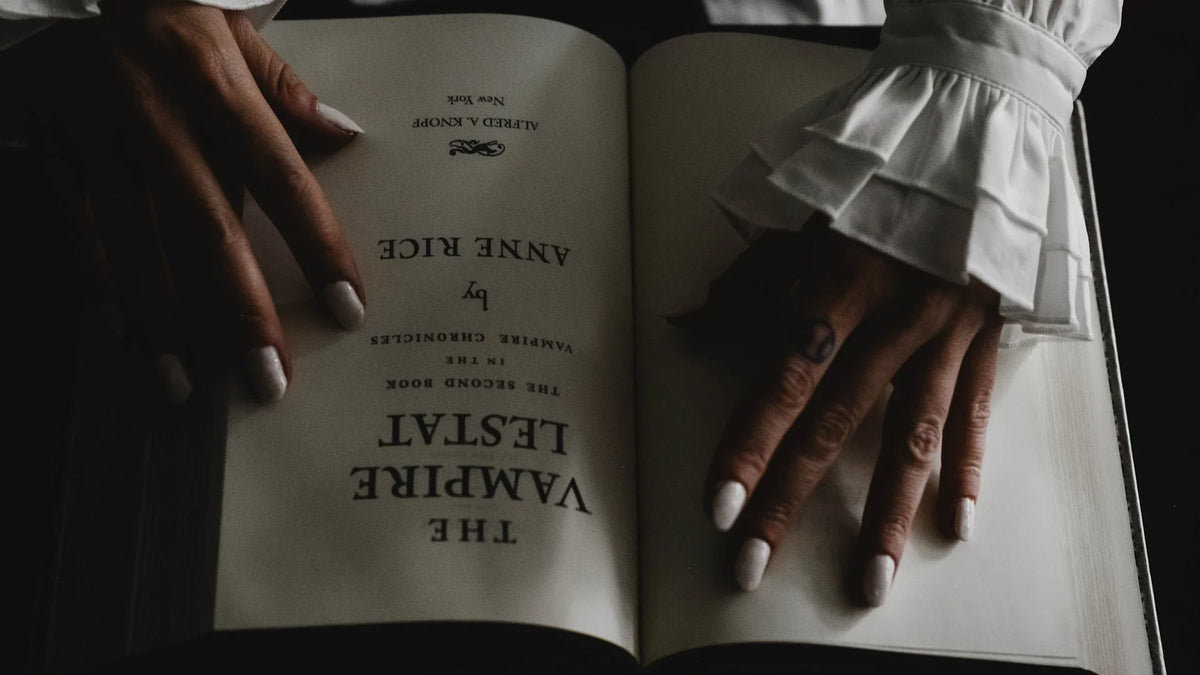 A woman’s hands hold an open book.