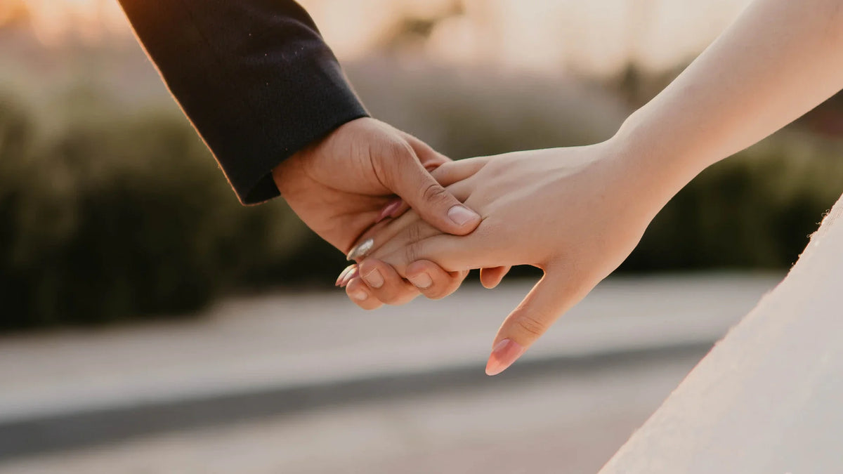 Two adult hands rest together.