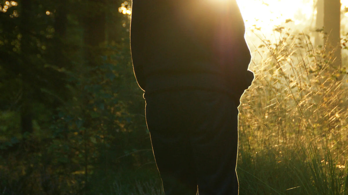An adult woman viewed from behind in natural light.