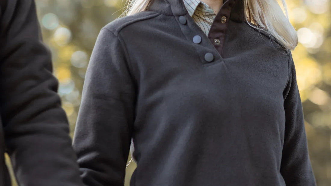 Cropped view of adult companions wearing outdoor clothing.