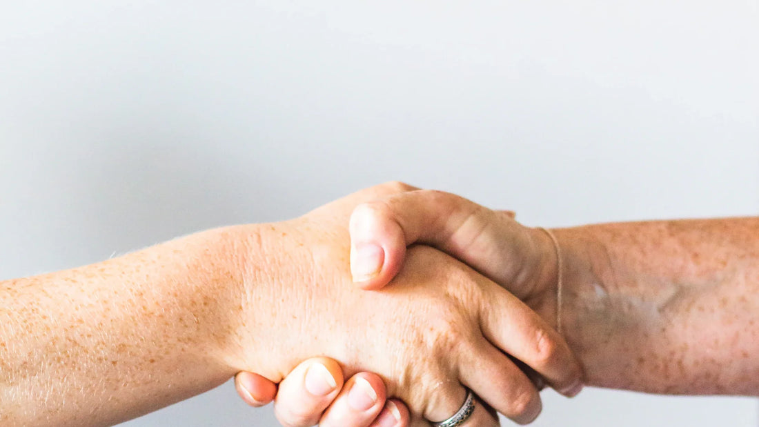 One adult holding another adult’s hands.
