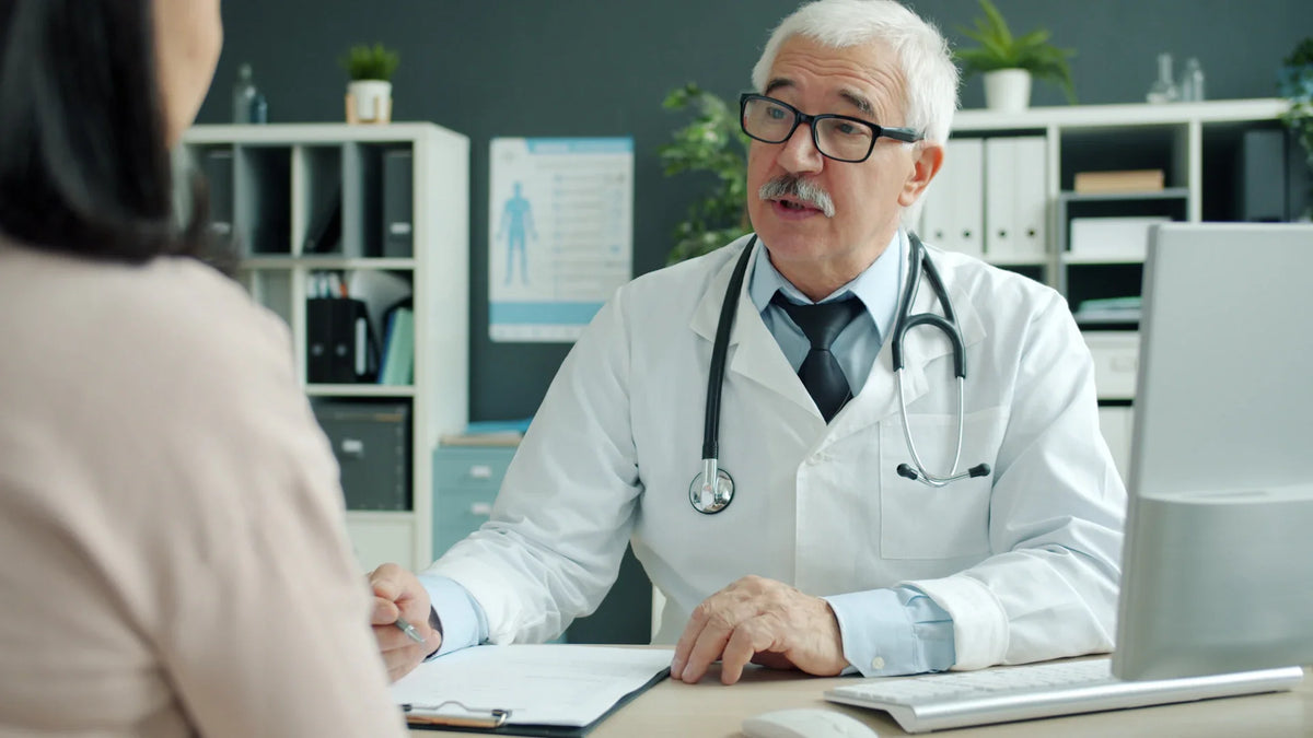 A doctor speaks with a woman during a medical appointment.