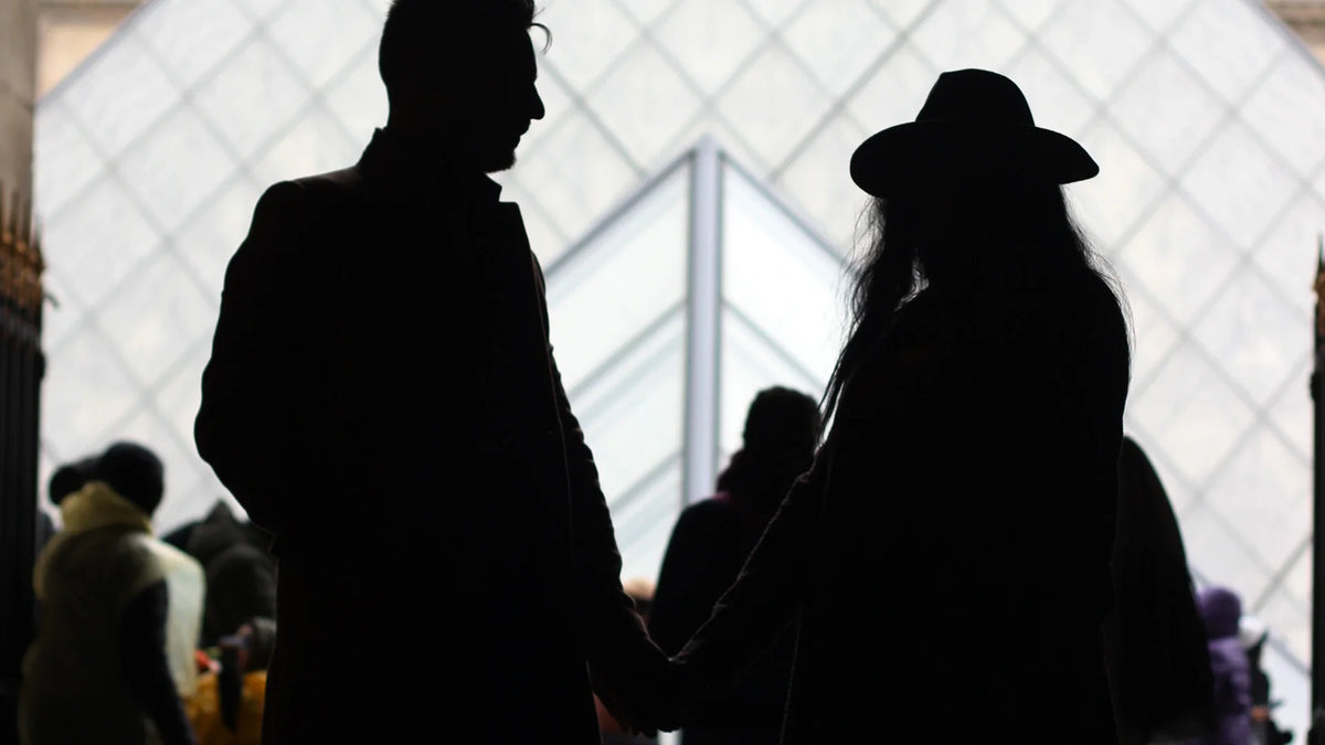 Adult companions silhouetted outdoors.