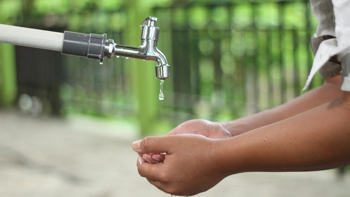 Hands being washed under running water.