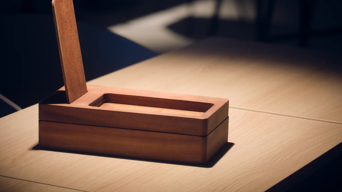 An open wooden storage box on a table.