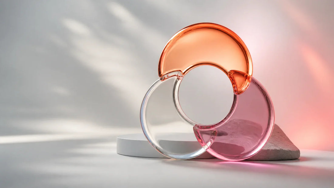 Three translucent geometric forms joined around an open center on a cool neutral background